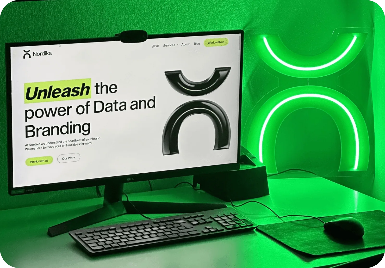 Nordika website on a desktop monitor lit in green