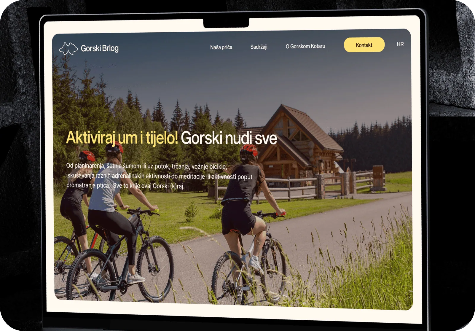 Gorski Brlog website on a tablet: cyclists on a forest trail